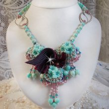 Collana Blue Flowers Haute-Couture ricamata con cristalli Swarovski, nastro di seta tartufo/raspberry e perle di semi